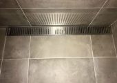 Tiled shower floor with custom grate